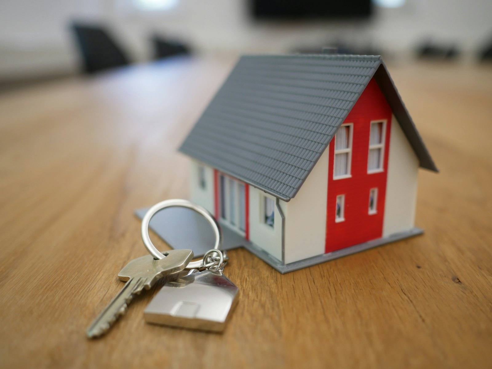 House keys resting beside a small model home